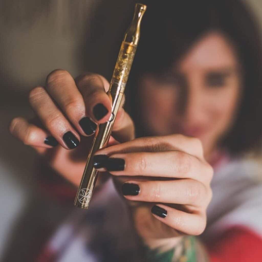 Tourist holding a CBD vape purchased at a smoke shop